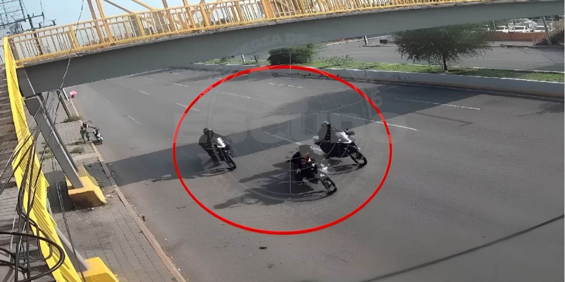 Three motorcyclists riding in a tight circle on a wet road beneath a yellow pedestrian bridge. The scene is circled in red for emphasis.